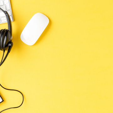 axvoice voip services features headset notebook white keyboard and mouse on yellow background